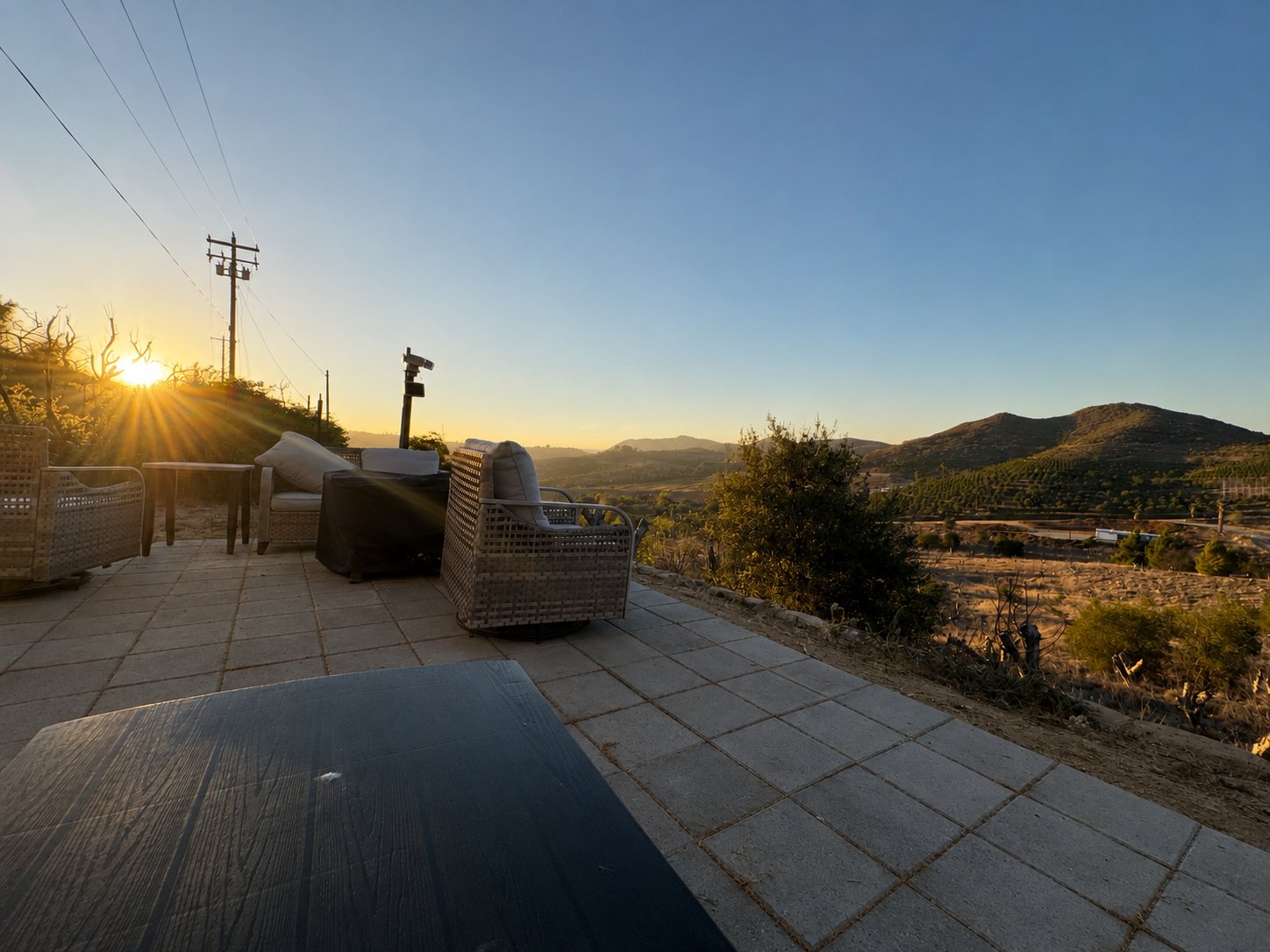 Outdoor patio seating overlooking the hills at sunrise