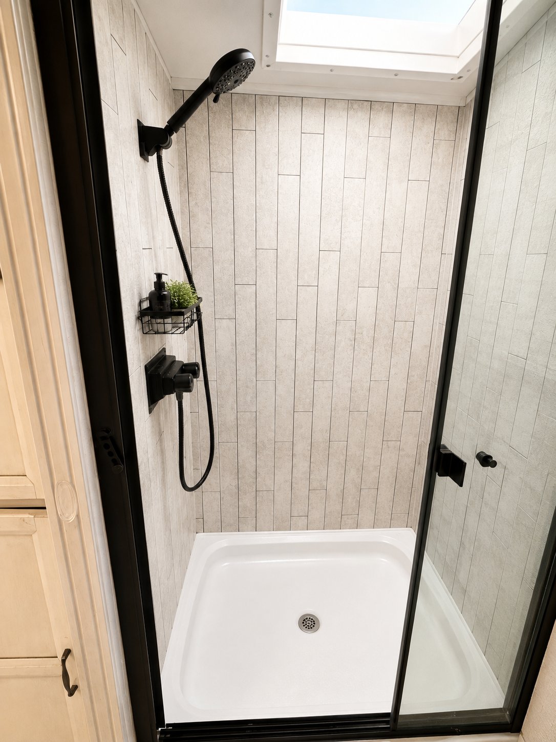 Shower with skylight, black hardware, and Vitamin C filtered shower head